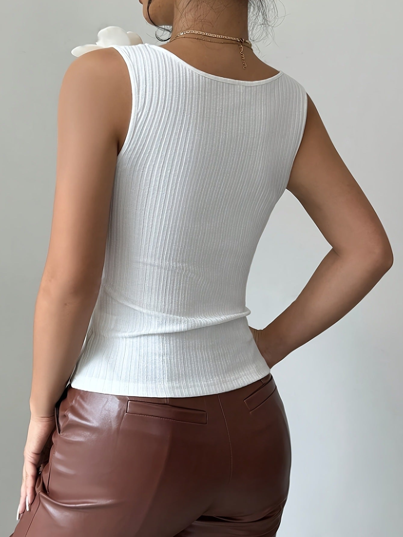 Stickad vit topp med elegant blomma