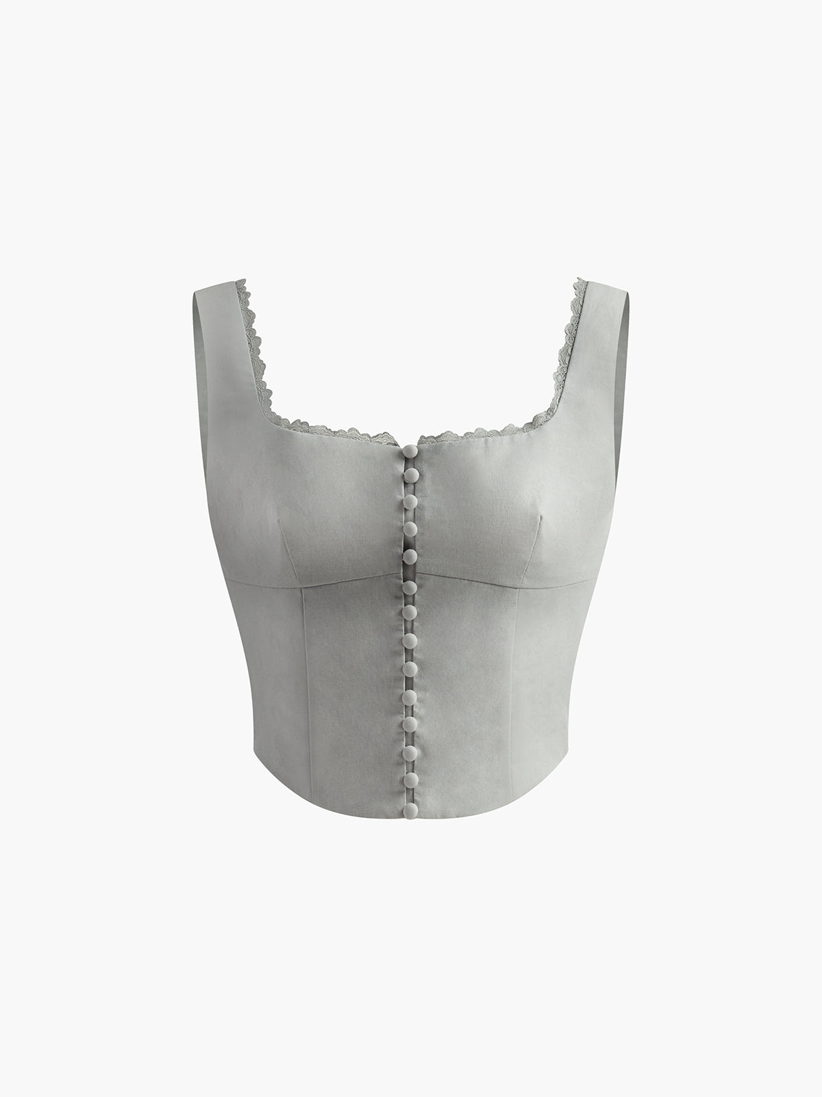 Vit korsettopp med knappdetaljer och spetskant