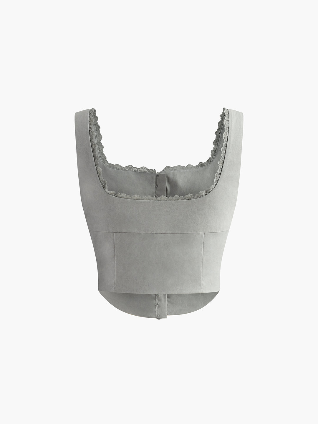 Vit korsettopp med knappdetaljer och spetskant