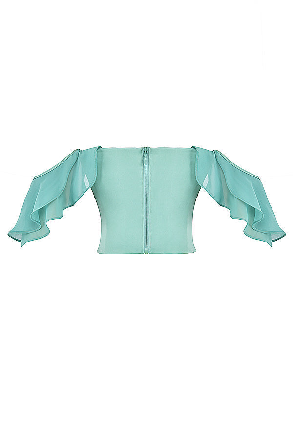 Jadekorsett med volanger på ärmarna och maxikjol med volanger